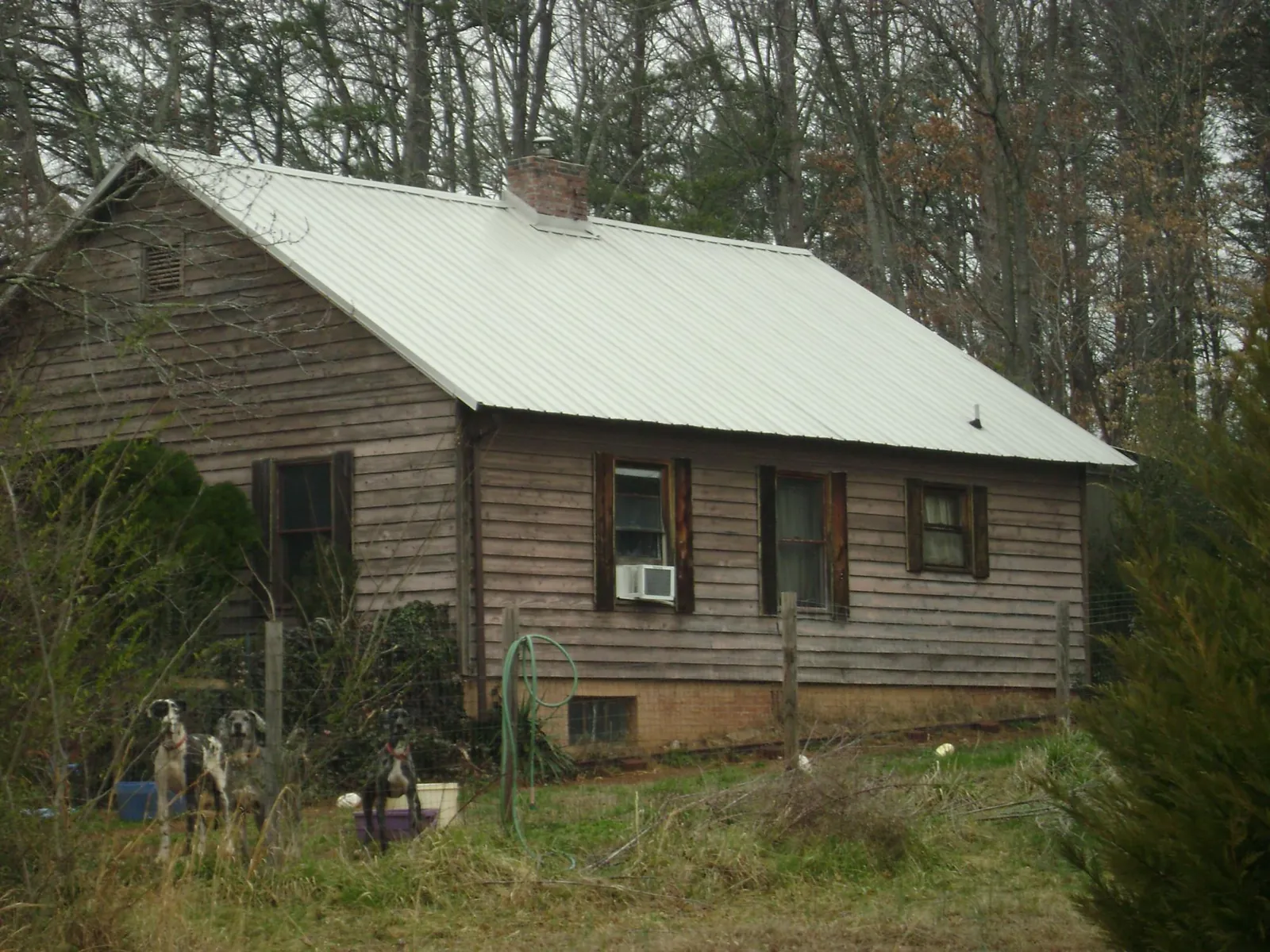 White metal roof on an old wood sided farmhouse, from a Asphalt Shingle Roof Repair job in Gordonsville